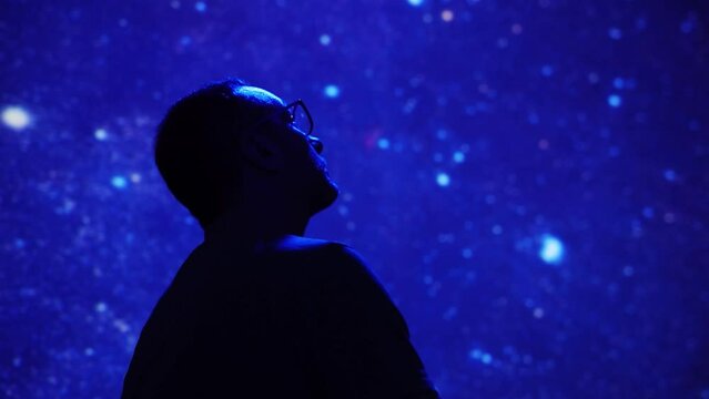 Silhouette of a man with Milky Way starry skies.