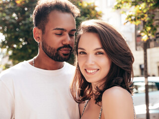 Smiling beautiful woman and her handsome boyfriend. Woman in casual summer clothes. Happy cheerful family. Female having fun. Sexy couple posing in the street at sunny day