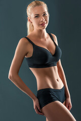 Fototapeta na wymiar Young beautiful woman in fitness wear trained female body