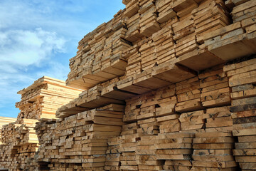 A large warehouse of wooden boards for construction.
