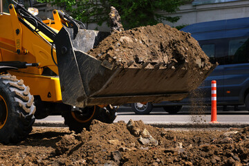 Close-up of excavator bucket on the street in the city.
