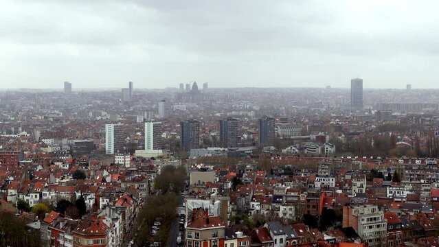 A panning video of Brussels cityscape from a top view. The camera sweeps around the city, showing the rooftops and buildings of the capital of Belgium. A scenic footage for travel or culture themes.