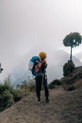 Silhouette of climber with their backpacks on top of the Acatenango volcano