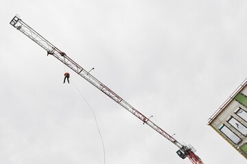 A firefighter abseils on a rope from the structure of a tower construction crane during training to...