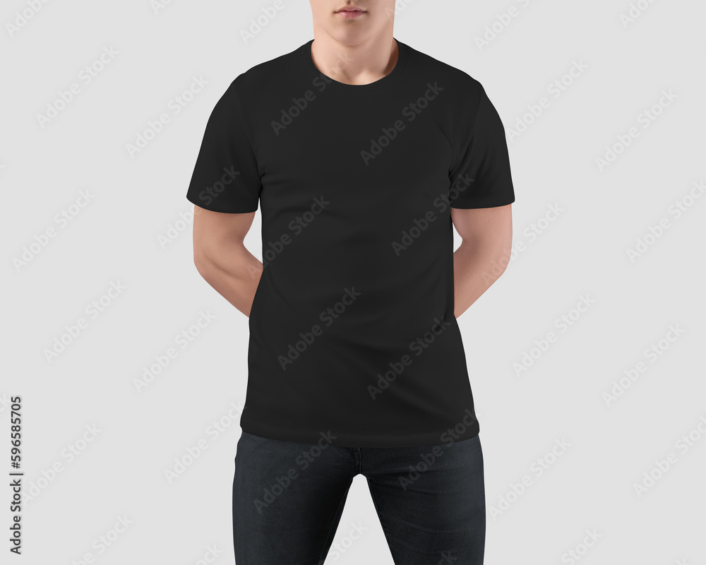 Wall mural Mockup of a black t-shirt on a guy with hands behind his back, blank shirt front view, product photography for commerce, promotion. - Wall murals