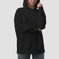 Obraz na płótnie Canvas Quality black hoodie template on a beautiful girl in a hood, empty apparel front view, women's shirt for design, brand, print.