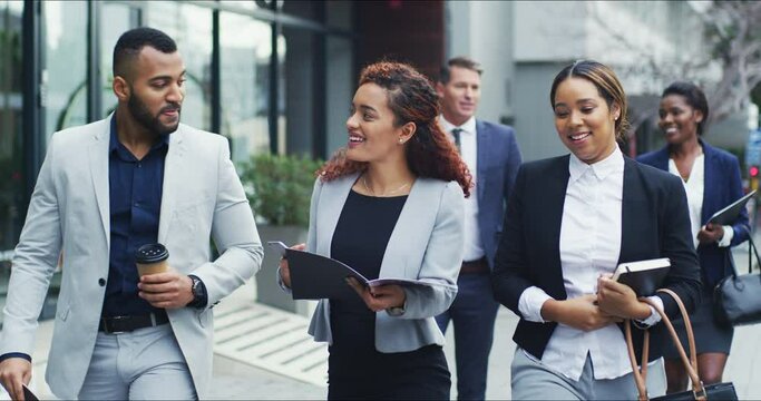 Collaboration, documents and a business team walking in a city while planning or talking strategy. Teamwork, diversity or discussion with men and women colleagues commuting together in an urban town