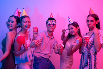 Five party goers being carefree and having a great time. 5 young people on a plain background lit...