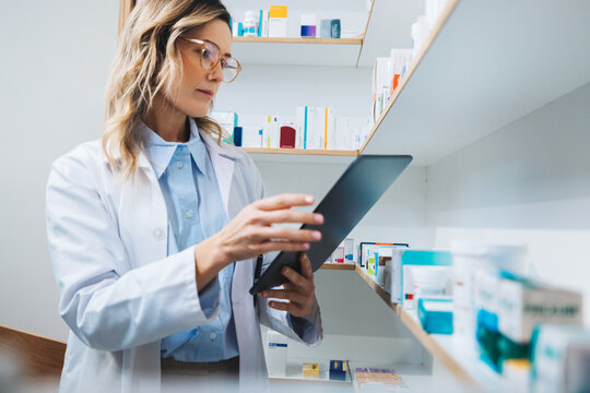 Doctor using a tablet in a pharmacy