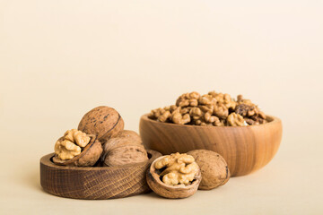 Fresh healthy walnuts in bowl on colored table background. Top view Healthy eating bertholletia concept. Super foods
