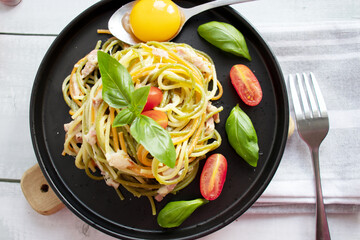 Pasta and bacon with parmesan. Homemade spaghetti pasta. On a wooden background