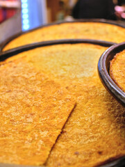Farinata, traditional Ligurian (italian) dish, oven-baked flatbread made only with chickpea flour,...