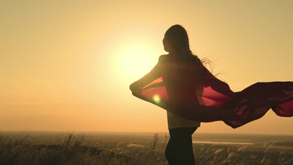 girl superhero sunset. man superhero red cape in the wind at dawn. red cape superhero concept....