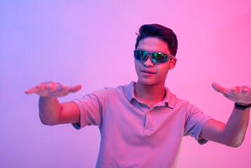A cocky and brash young asian man wearing shades feeling handsome and cool. Party vibe with blue...
