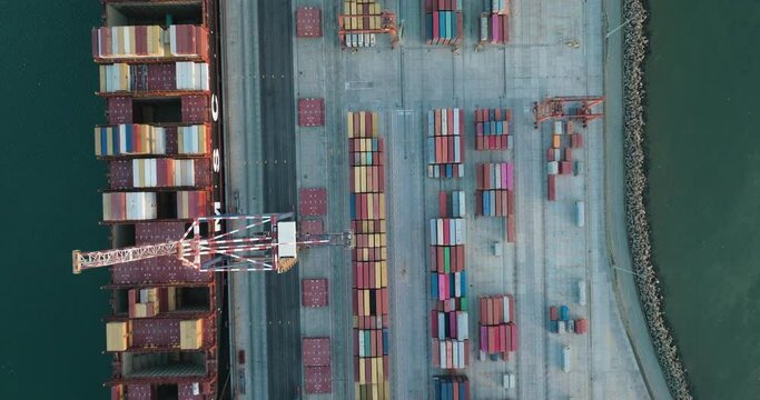 Straight down aerial.Containers and Container ships at the dock in a harbour. Global supply chain.Logistics.Distribution