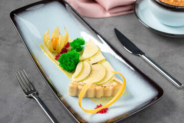 Apple tart on stone table in fine dining restaurant