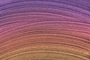 俯瞰で見た砂の写真、桃色系のグラデーション