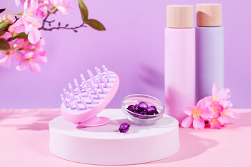 Obraz na płótnie Canvas Scalp massage and cleansing shampoo brush with hair vitamins and serum on podium, copy space