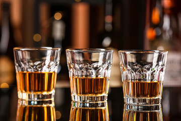 Glasses of cold rum on table in bar
