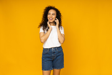 Young woman in casual summer wearing on yellow background