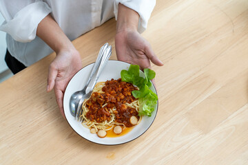 Female hands with Spaghetti Tomato Sauce on table