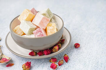 Bowl with tasty Turkish Delight on light background