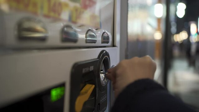 Putting coins into a vending machine and select a drink