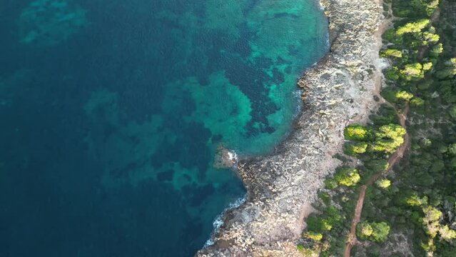 Flying On The Pristine Bay With Vegetations Over Rugged Cliffs Near Sa Coma In Mallorca Spain. Aerial Drone Shot