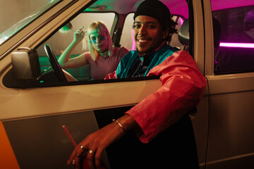 Man with drink in car.