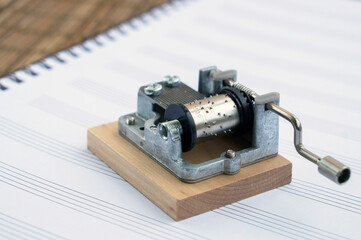 Mechanical retro music box on music sheets
