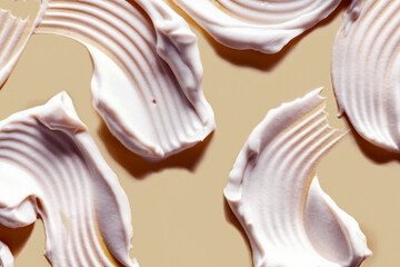 Cosmetic products creamy texture smudge nude coral beige yellow background