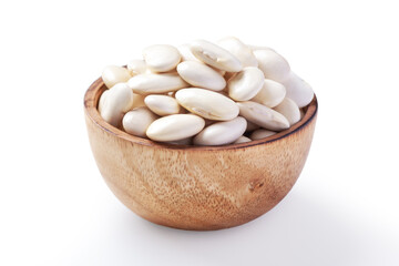 Raw white beans in wooden bowl isolated on white