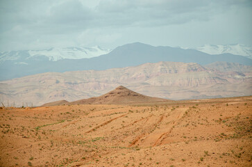 Desert landscapes in Morocco, desolate lands with paths that lead to remote and unexplored corners. Climate change and arid climate. Desertification and lack of water. Mountains and hills 