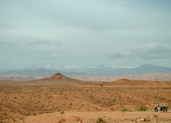 Naklejka premium Desert landscapes in Morocco, desolate lands with paths that lead to remote and unexplored corners. Climate change and arid climate. Desertification and lack of water. Mountains and hills 