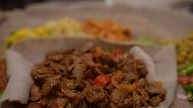 Close up tracking shot of Beyaynetu - Ethiopian cuisine