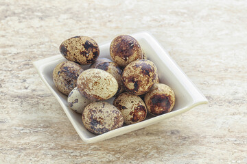Raw quail eggs heap in the bowl