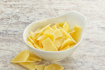 Sliced parmesan cheese heap in the bowl