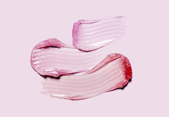 Fototapeta premium Cream balm cosmetic texture smudge or lip gloss on pastel pink background