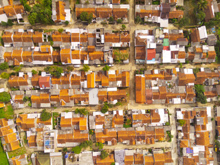 Fototapeta premium Aerial photography. Aerial drone view of one residential at Bandung city - Indonesia, with green fields and many houses