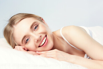 Fototapeta premium Pretty woman lying down on her bed at home.