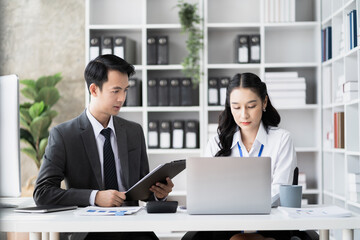 Businessmen team or financial data analysts working with tablets and laptop computers and data graphs together. Plan to analyzing projects in the office.
