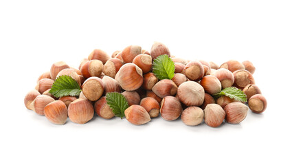 Shelled hazelnuts with leaves on white background