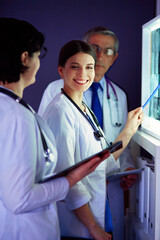 Group of doctors in a hospital. X-ray diagnostics. - 596617315