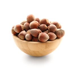 Bowl with shelled hazelnuts on white background