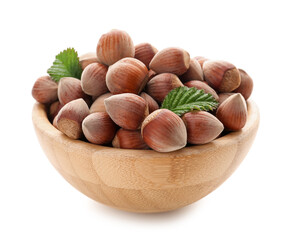 Bowl with shelled hazelnuts on white background