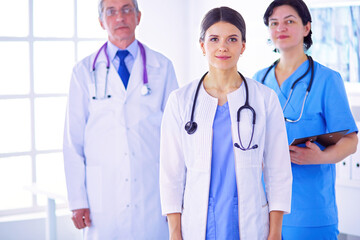 Group of doctors and nurses standing in the hospital room