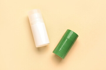 Two deodorant bottles on yellow background