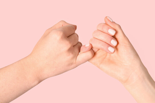 Women and man hands hook pinky fingers together to promise,Loving