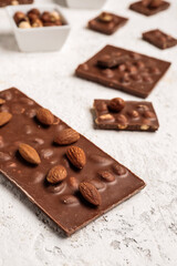 Sweet tasty chocolate with nuts on  light background