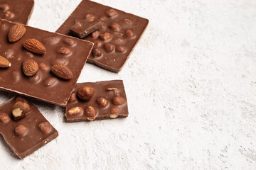 Sweet tasty chocolate with nuts on  light background